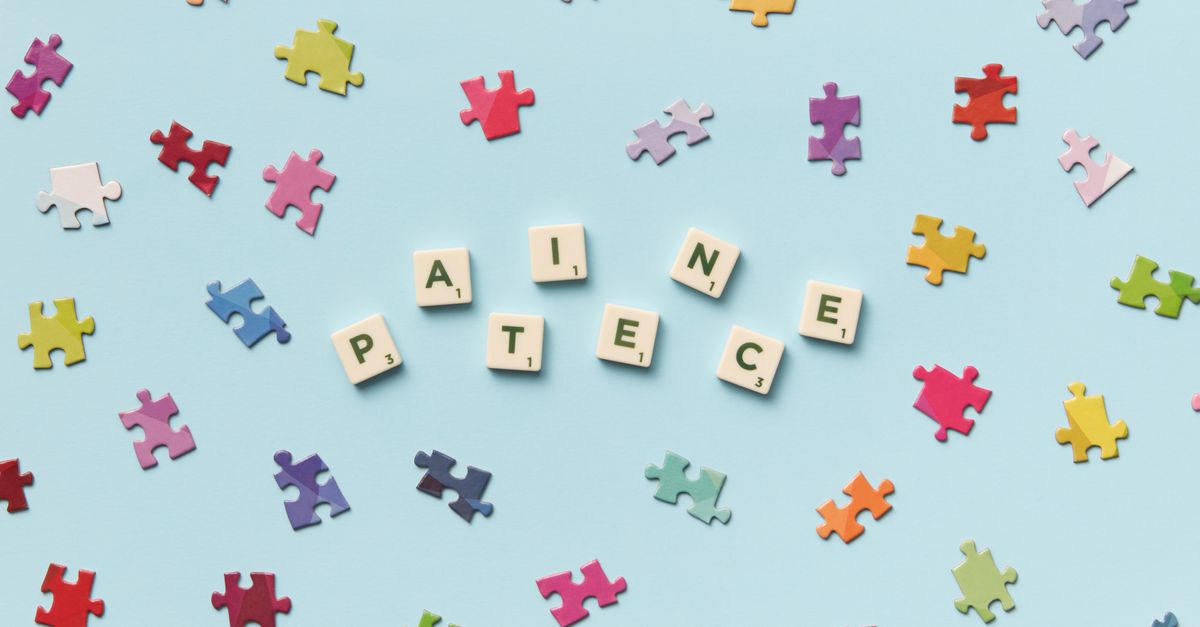 Scattered jigsaw puzzle pieces and Scrabble letters spelling 'PATIECE' on a light blue background.